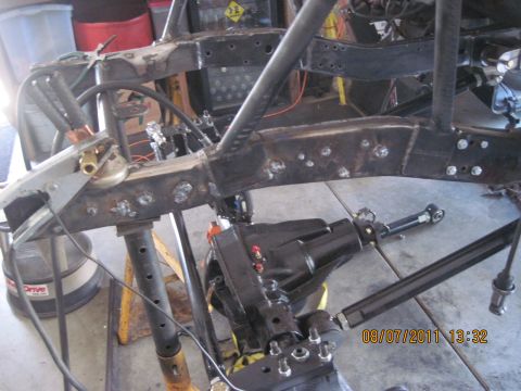 1985 Jeep CJ7 - Close-up of a vehicle's frame and differential, showing custom fabrication work.