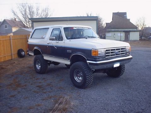 1988 Ford Bronco - This lifted Ford Bronco has a two-tone paint scheme and sits on large off-road tires.