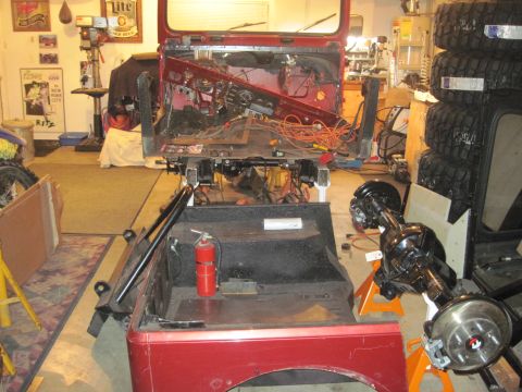 1985 Jeep CJ7 - 1985 Jeep CJ7 undergoing restoration in a garage with parts laid out.