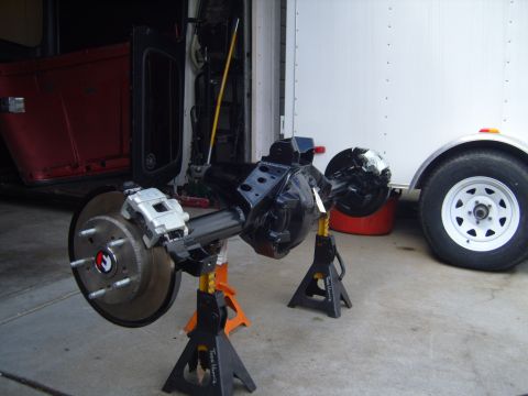1985 Jeep CJ7 - Rear axle assembly for a Jeep, possibly a CJ7, on jack stands in a garage.