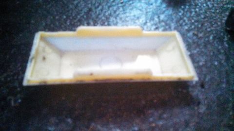 1979 Ford Bronco - A yellow plastic part with a white interior is shown from a top-down perspective.