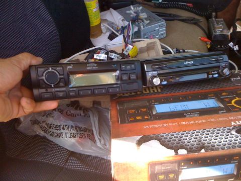 1997 Dodge 3500 - Several car stereo units and wiring are visible, with one unit being held by a hand.