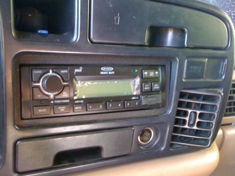 1997 Dodge 3500 - Close-up of a car's interior dashboard, focusing on the stereo system and surrounding controls.