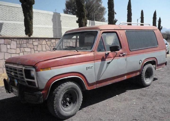 Red and gray Ford Bronco parked outside