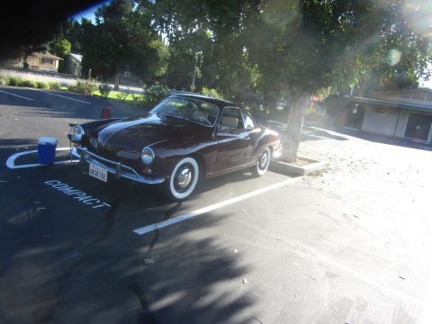 1968 Ford Mustang - This Volkswagen Karmann Ghia coupe is parked in a spot marked 'COMPACT'.