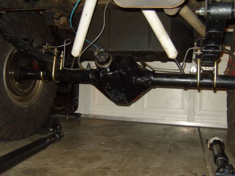 1985 Jeep CJ7 - Close-up view of a vehicle's rear axle assembly, showing suspension components and the differential housing.