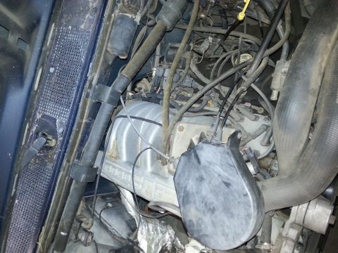 1989 Ford F-150 - Close-up view of a vehicle's engine bay, showing various mechanical parts and wiring.