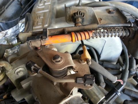 1989 Ford F-150 - This is a close-up view of engine components, specifically the throttle body and associated linkage.