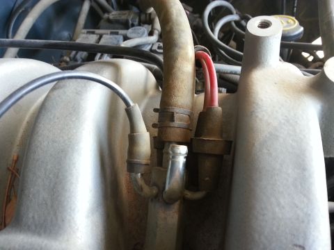 1989 Ford F-150 - Close-up view of engine components, including hoses and wiring, in an engine bay.