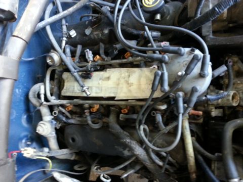 1989 Ford F-150 - Close-up view of a vehicle's engine bay, showing various components and wiring.