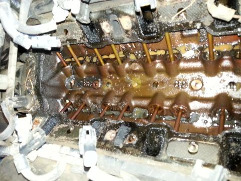 1989 Ford F-150 - Close-up view of an engine component, showing internal parts and signs of wear.