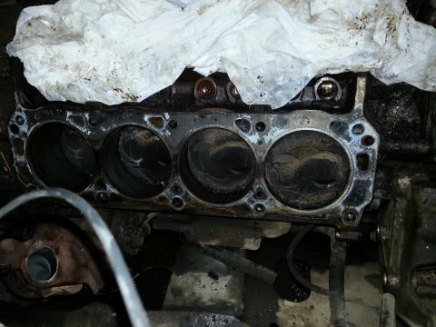 1989 Ford F-150 - Close-up view of an engine block, showing the cylinder bores and a white cloth covering part of the engine.
