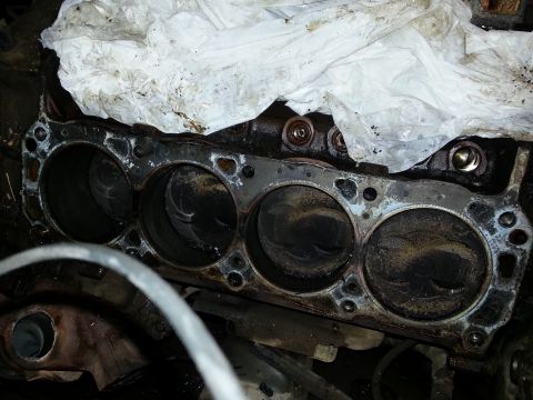 1989 Ford F-150 - Close-up of an engine block showing cylinders and pistons, partially covered.