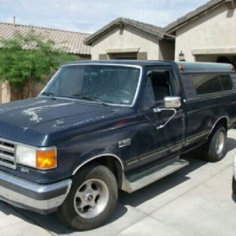 1989 Ford F-150 - This 1989 Ford F-150 pickup truck is parked in front of a house.