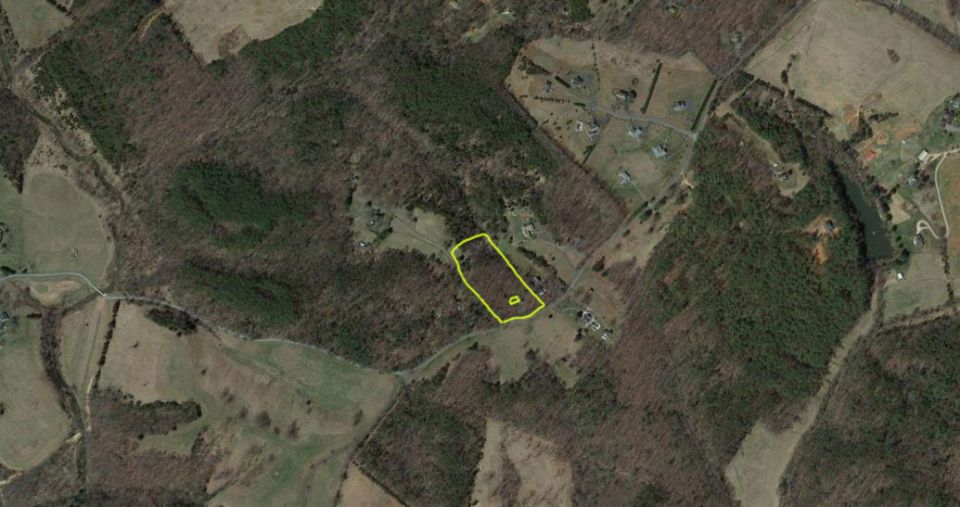 Aerial view of a rural property with a yellow outline around a section of land