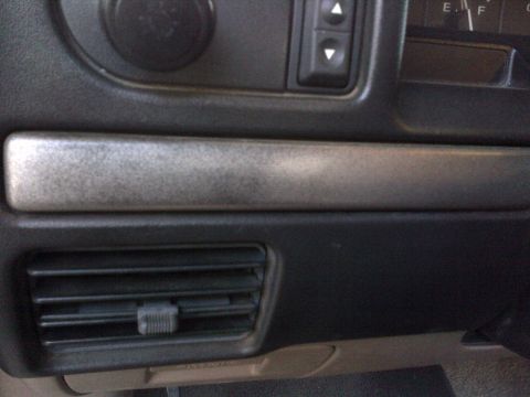 1994 Ford Bronco - Interior view of a 1994 Ford Bronco, showing the dashboard trim and air conditioning vent.