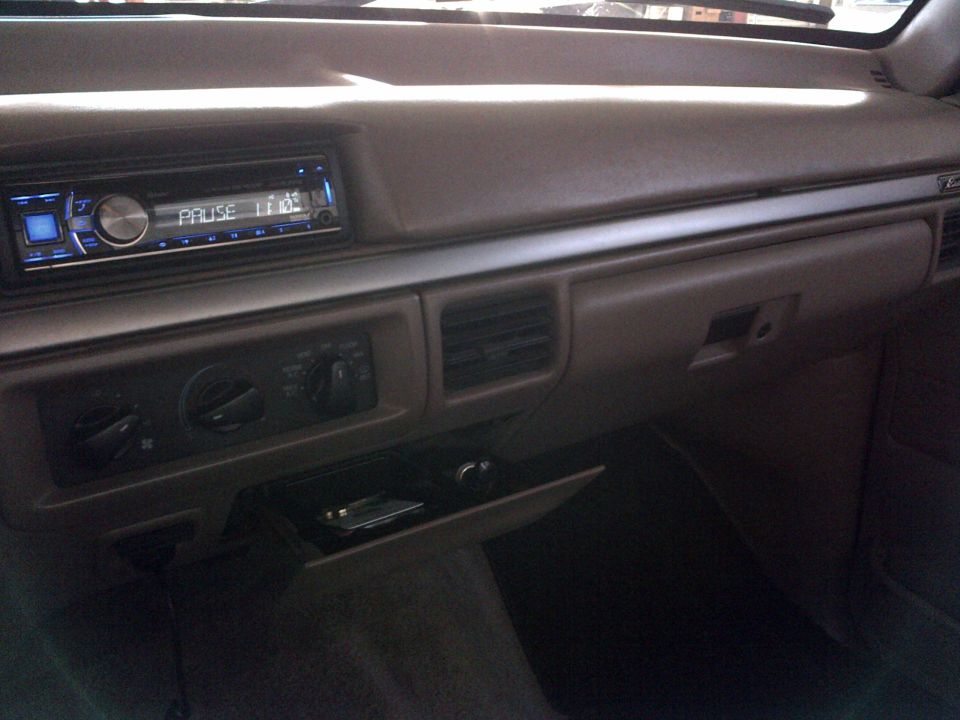 Dashboard of a vehicle with an aftermarket stereo and climate controls