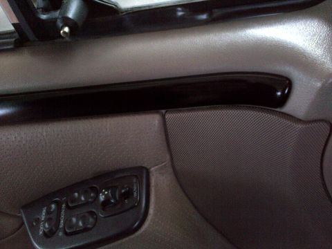 1994 Ford Bronco - Interior door panel of a 1994 Ford Bronco, showing power window and lock controls.