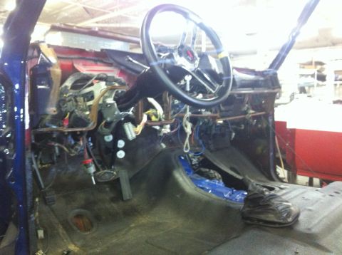 1982 Ford Bronco - The interior of a vehicle is visible, with exposed wiring and a removed dashboard.