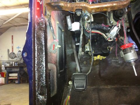 1982 Ford Bronco - Interior view of vehicle with exposed wiring and pedals, likely undergoing repair or modification.