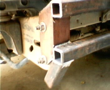 1991 Ford Bronco - Close-up of a custom bumper assembly, square tubing and robust mounting points. Text from Supermotors.net is visible.