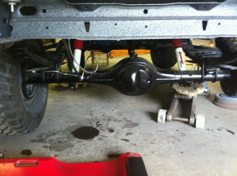 1982 Ford Bronco - Undercarriage view of a vehicle's rear axle and suspension system.