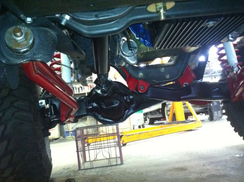 1982 Ford Bronco - The underside of a vehicle is shown, highlighting its suspension and drivetrain components.