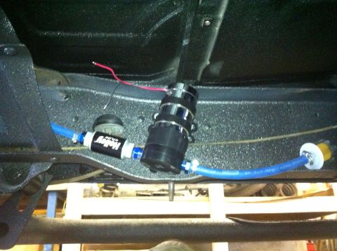 1982 Ford Bronco - Aftermarket fuel pump and filter assembly installed on vehicle frame.