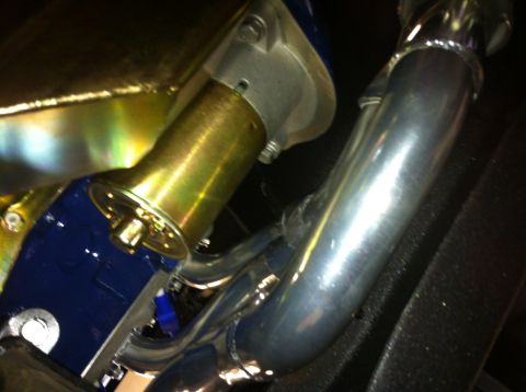 1982 Ford Bronco - Engine starter motor and exhaust pipes are visible in this close-up shot.