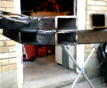 1991 Ford Bronco - Close-up of a fabricated bumper or frame weldment built from square steel tubing, showing the open tube ends, fresh weld beads at the joint…