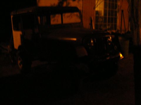 Jeep CJ-8 Scrambler parked outside at night