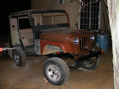Jeep CJ-5 body, brown and tan, missing doors and roof, on trailer