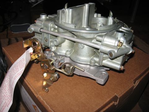 1981 Ford Bronco - A Holley 80555 carburetor is shown with an attached instruction tag, resting on a cardboard box.
