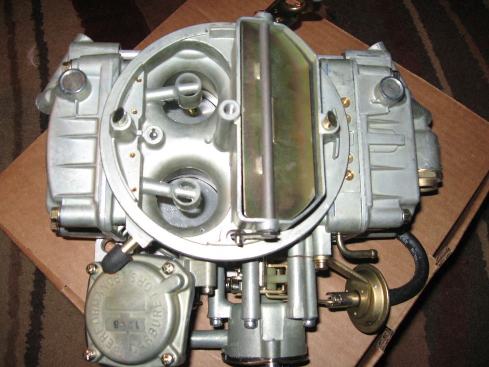 Holley carburetor with "PERFORMANCE" and "PURE" visible on a circular plate