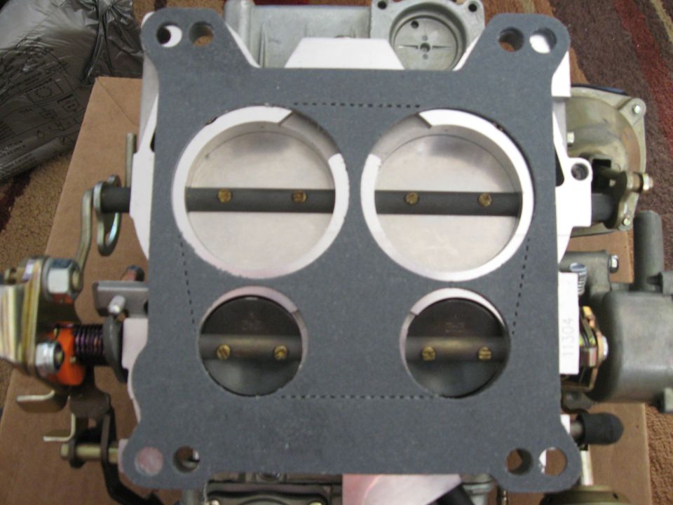 Carburetor with a new gasket installed over the throttle plates