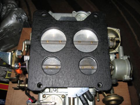 1981 Ford Bronco - Close-up of a Holley 4-barrel carburetor, showing the four throttle plates and part numbers.