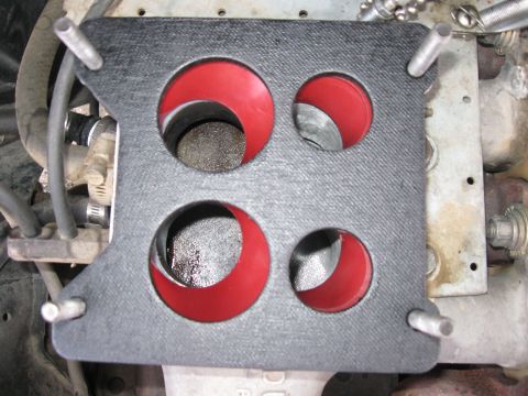 1981 Ford Bronco - A Holley 80555 carburetor spacer with four red-lined openings is shown installed on an engine.