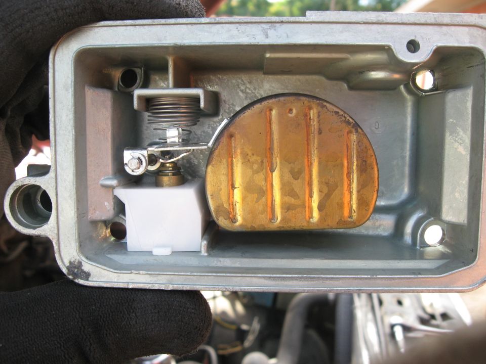 Carburetor float bowl with brass float and spring mechanism