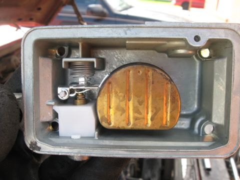 1981 Ford Bronco - Close-up of the inside of a carburetor float bowl, showing the float and related components.