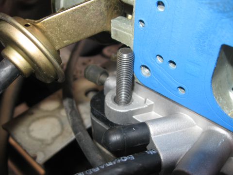 1981 Ford Bronco - Close-up view of a carburetor stud and blue gasket, part of an engine component.