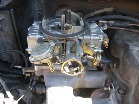 1981 Ford Bronco - A detailed view of a Holley carburetor, a critical engine component for fuel delivery.