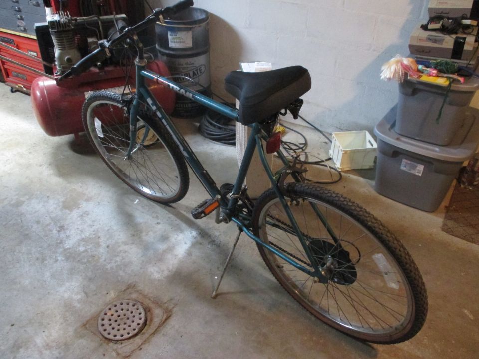 Teal bicycle with black seat and kickstand