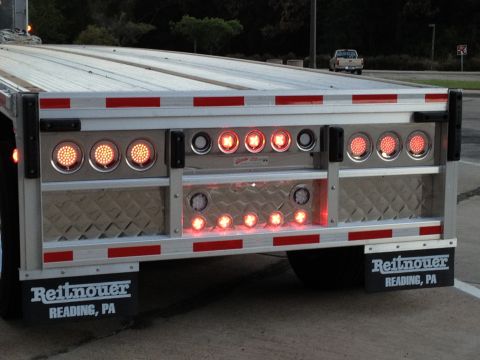 2003 Peterbilt 379 - Trailer rear lights and mud flaps are visible, with a pickup truck in the background.
