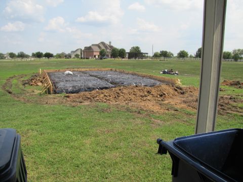 1995 Ford Bronco - Foundation being prepared for construction on a sunny day with houses in the distance.