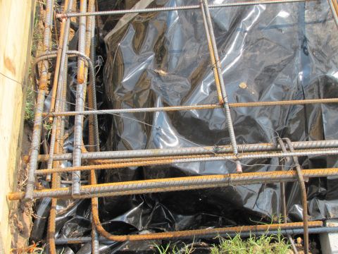 1995 Ford Bronco - Construction materials, including rebar and plastic sheeting, are prepared for a concrete pour.