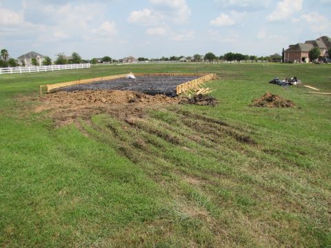 1995 Ford Bronco - A construction site is being prepared with foundation forms and dirt piles on a grassy field.