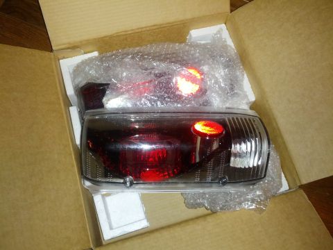 1979 Ford F-150 - New red tail lights, still in original packaging, ready for installation.