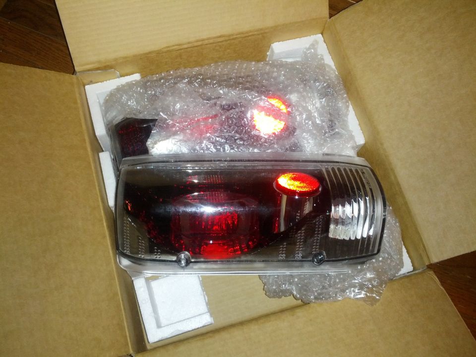 Pair of new red tail lights in box