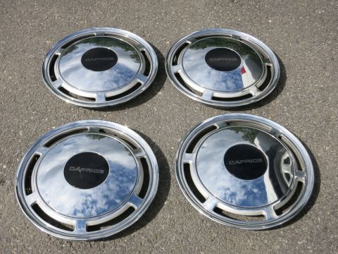 1991 Ford LTD Crown Victoria - Set of four chrome hubcaps the "CAPRICE" name on their black center caps.