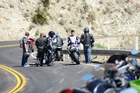 1995 Ford Taurus - A group of motorcyclists pauses on a scenic route, with several bikes visible.